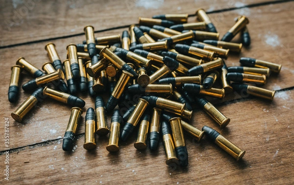 Obraz .22 ammunition in pile on a board surrounded by powder