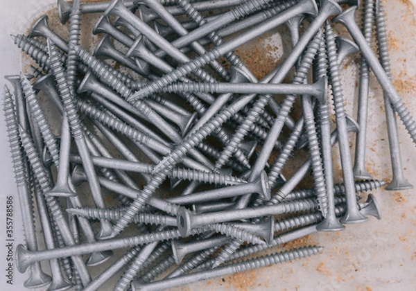 Obraz Bugle Batten Screws in box with saw dust scattered through box