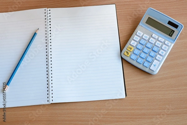 Fototapeta Stationary and blank books on the table, pencil set ,cup of coffee and calculator on wood table , copy space of stationary , working space, space work from home