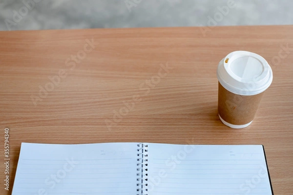 Fototapeta Stationary and blank books on the table, pencil set ,cup of coffee and calculator on wood table , copy space of stationary , working space, space work from home