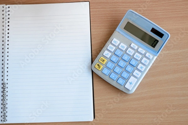 Fototapeta Stationary and blank books on the table, pencil set ,cup of coffee and calculator on wood table , copy space of stationary , working space, space work from home