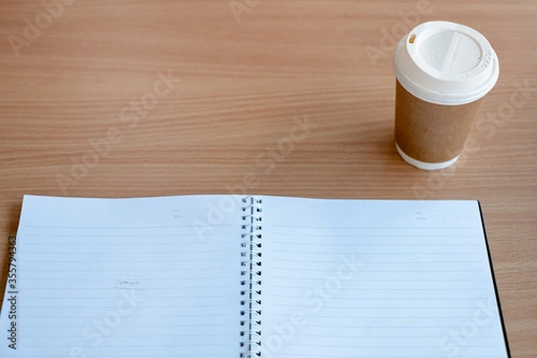 Fototapeta Stationary and blank books on the table, pencil set ,cup of coffee and calculator on wood table , copy space of stationary , working space, space work from home