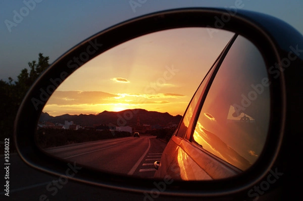 Obraz reflection seen through car side mirror - sunset
