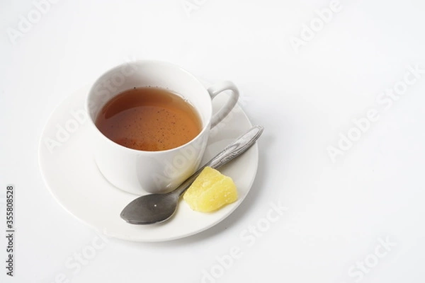 Obraz Fresh a cup of tea with rock sugar isolated on white