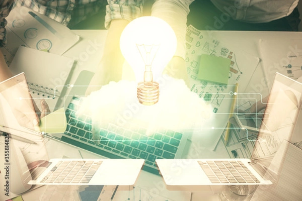 Fototapeta Double exposure of man and woman working together and bulb drawing. Computer background. Top View. Idea concept.