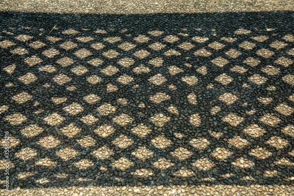 Fototapeta Shadow grid Geometric Design  in asphal on on asphalt ground