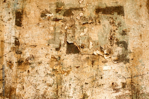 Fototapeta Texture and faded and peeling paint on a section of timber