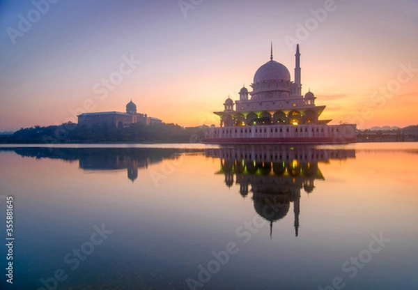 Fototapeta Beautiful sunrise in putrajaya malaysia with reflection in lake water with mosque in visibility. Putrajaya in administrative capital of malaysia. Selective focus.