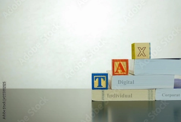 Fototapeta Conceptual image of annual tax return. Stacked wooden block letter forming TAX on dark reflective surface. Focus at block letter A.