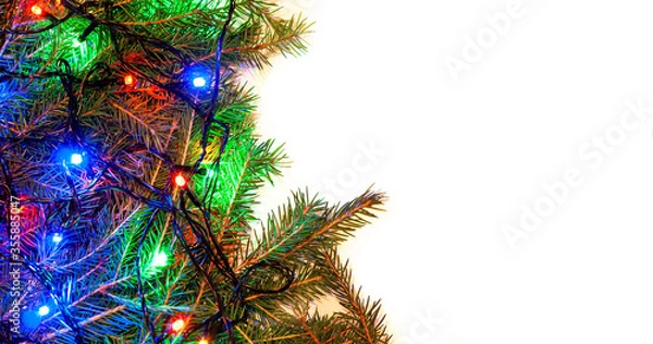Fototapeta Christmas white background with spruce branches and colorful garlands on the side of the frame. Design template for Happy New Year and Marry Christmas.