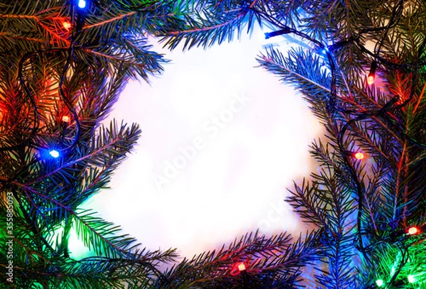 Fototapeta Christmas background with spruce branches and colorful garlands. Design template for Happy New Year and Marry Christmas.