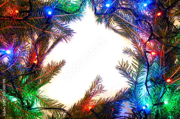 Fototapeta Christmas background with spruce branches and colorful garlands. Design template for Happy New Year and Marry Christmas.