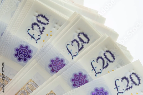 Obraz Corner of the stack of 20 pound banknotes isolated on white. Photo of new polymer 20 pound note released in februrary 2020 in the United Kingdom.