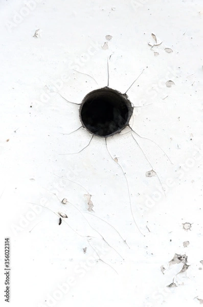 Obraz Black hole in white wall