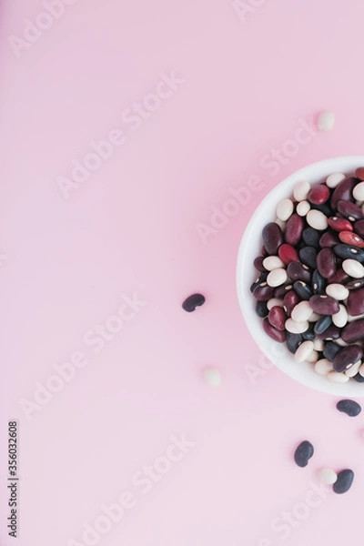 Fototapeta raw beans in a cup on the background