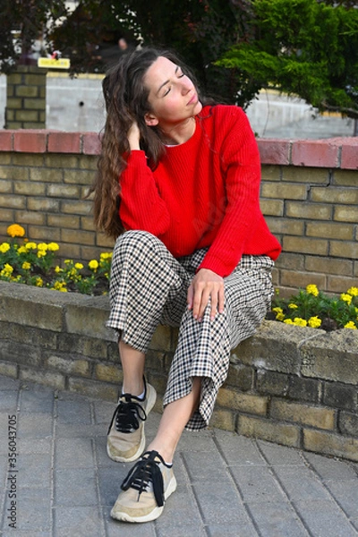 Fototapeta young girl posing in a red sweater