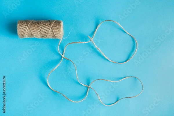 Fototapeta Jute twine on the blue background. View from top, copy space. 