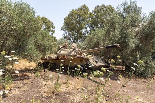 Fototapeta A battered  Syrian tank of Soviet manufacture is after the Doomsday (Yom Kippur War) on the Golan Heights in Israel, near the border with Syria