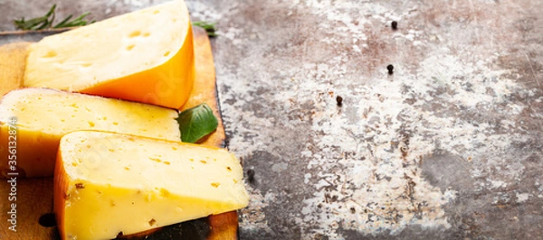 Obraz top view on cheese lying on rustic background