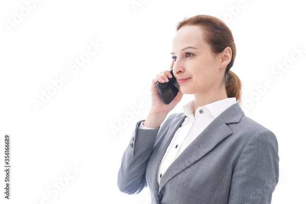 Fototapeta スマートフォンを使うスーツを着たビジネスウーマン