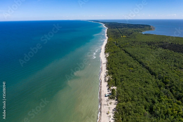 Fototapeta Beautiful view from above of the Curonian spit national Park. On the right - the blue Baltic sea, on the left-the Curonian lagoon. A sandy strip of beach stretches away into the distance.