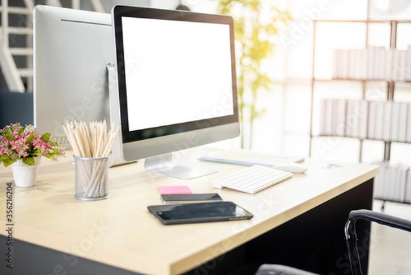 Fototapeta Workplace with computer screen mockup in modern office background