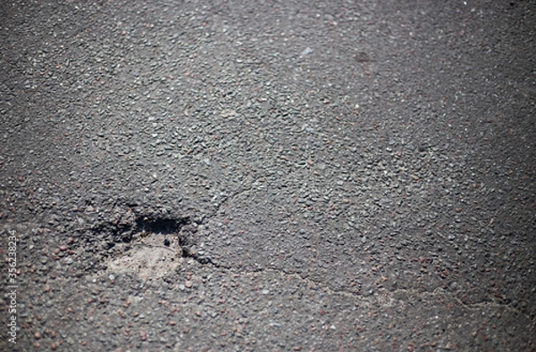 Fototapeta Broken asphalt and cracks on the road surface