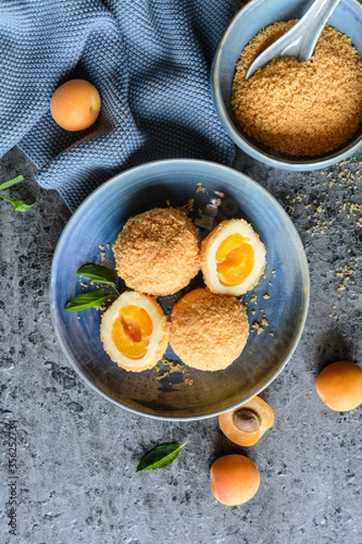 Fototapeta Marillenknödel – sweet dumplings stuffed with apricot and coated with breadcrumbs