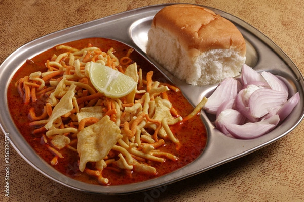 Obraz A popular Indian food item from Maharashtra, called misal pav. Misal pav is a gravy based food item eaten with Indian bread, very popular in Maharashtrian food item.