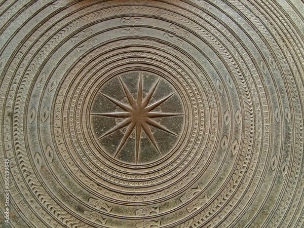 Fototapeta Close-up top view of ancient Dong Son Drum (Frog Drum, Rain Drum) covered with old green patina.