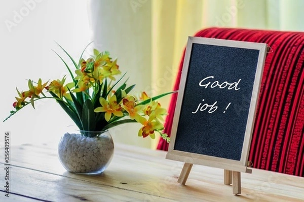 Fototapeta Image of motivational greeting good job on chalk board. Besides a decorative green plant in vase. Selective focus on notice board. Others in gradient blur.