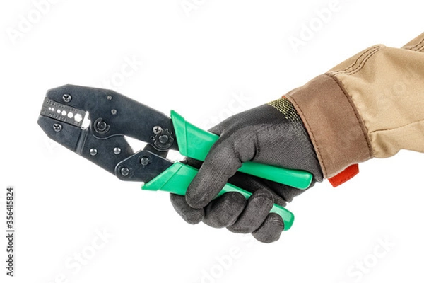 Obraz Crimping pliers with green handles for mounting BNC connectors in electrician hand in black protective glove and brown uniform isolated on white background
