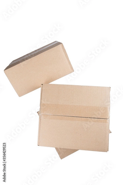 Fototapeta isolated close up shot of three stacked closed rectangular blank brown carton cardboard boxes on a white background