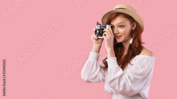 Obraz Photographer Girl Taking Photo On Retro Camera, Pink Background, Panorama