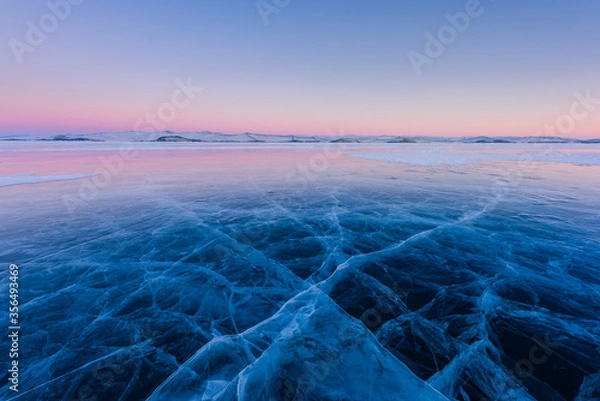 Obraz Early morning on the ice of lake Baikal against the background of mountains and ice