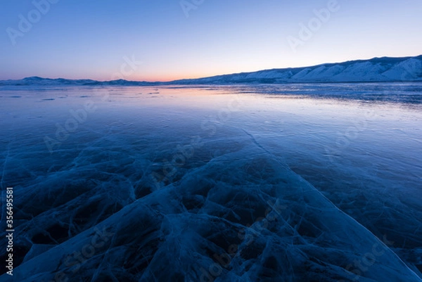 Obraz Early morning on the ice of lake Baikal against the background of mountains and ice