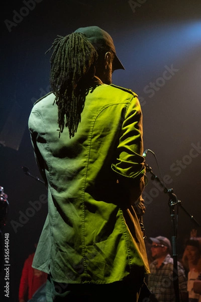 Obraz reggae musician playing the saxophone at a live event in Pennsylvania  at a concert on a tour with a Jamaican band 