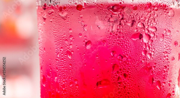 Fototapeta red soda water splashing with bubbles close up and Dew Point on glass