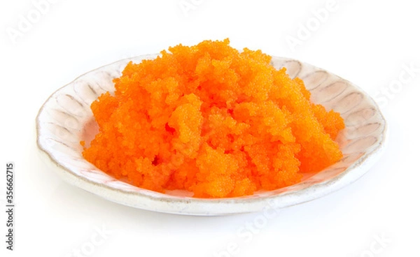 Fototapeta Tobiko egg is orange (flying fish roe) on white plate. Fushion food style Japanese for cooking rice don,nikiri or sushi side view isolated on white background