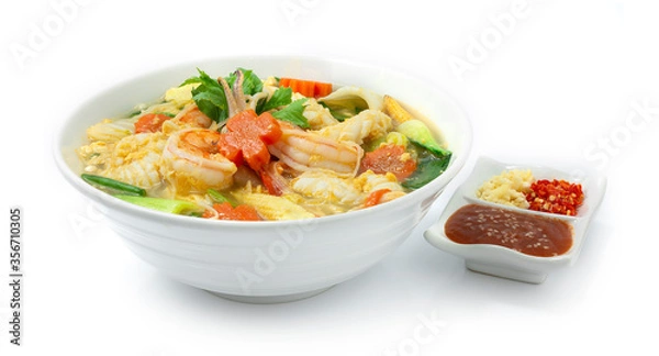 Fototapeta Thai Sukiyaki Soup with Seafood Shrimps,Squids,Egg and Vegetables Carved Carrots flowers shape served Sauce