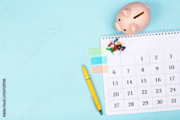Fototapeta white calendar 2020 month schedule to make appointment meeting or manage timetable each day lay on blue background for planning work and life concept