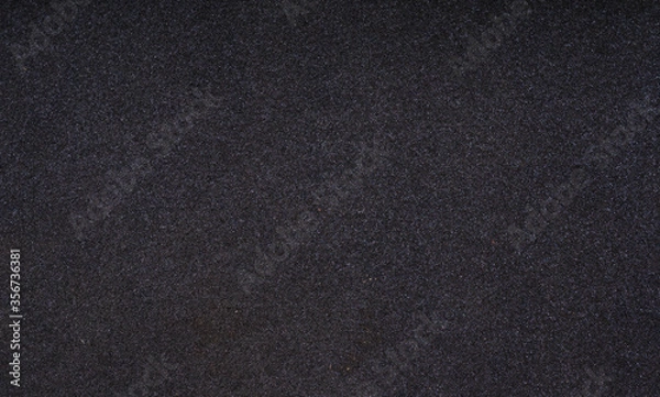 Fototapeta Closeup shot of black foam rubber. Thin sheet of black foam rubber texture