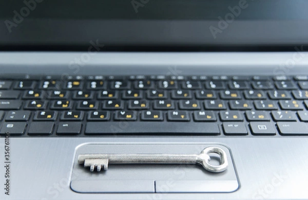 Fototapeta Internet security and data protection concept. Cybersecurity concept. Key on black and gray computer keyboard - computer security concept. Selective focus