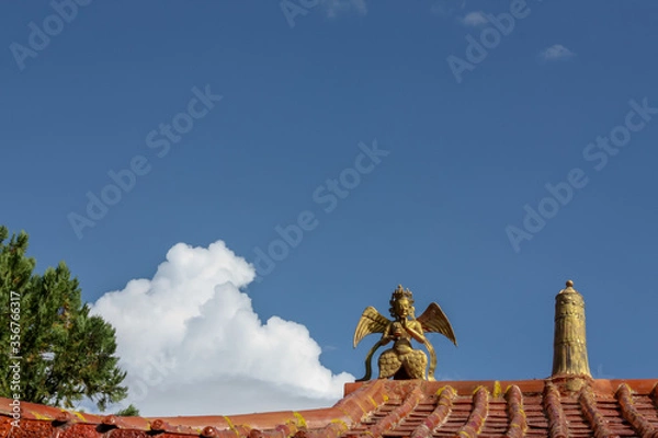 Fototapeta Norbulingka Summer palade of Dalai Lama in Lhasa, Tibet, roof with golden idol and stella