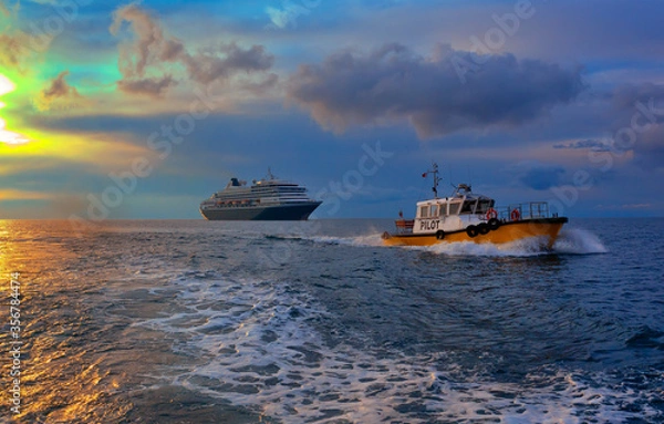Fototapeta Cruise ship leaves the port, accompanied by a pilot boat.