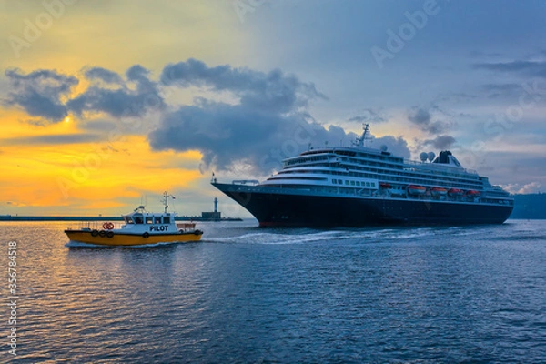 Fototapeta Cruise ship leaves the port, accompanied by a pilot boat.