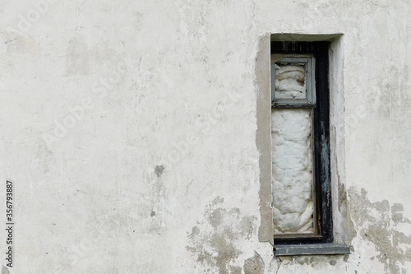 Fototapeta Boarded building window with burnt discolored planks. 