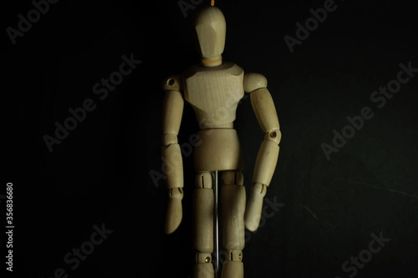 Obraz wooden mannequin hang man on black background