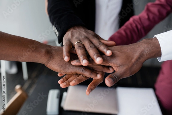 Fototapeta The hands of black people in the center hold each other to unite against racism in large countries. Black lives matter