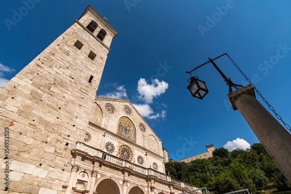 Fototapeta spoleto, cathedral, view from below, sky background with clouds